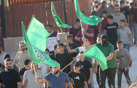 Palestinians from Hamas hold banners during the funeral of Qusai Nasser, 23, who was killed in an Israeli military raid on his home in the village of Salem, east of Nablus in the West Bank.
Israeli special forces reportedly surrounded the house and opened fire, resulting in Nassar’s death and injuring another person.