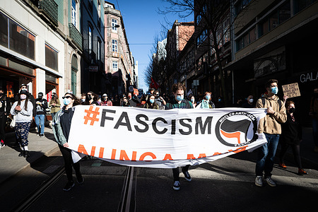 Protesters marching with a huge banner expressing their opinion, during the World Against Racism demonstration organized by Núcleo Antifascista do Porto (Antifascist Porto) to mark the International Day Against Racial Discrimination.