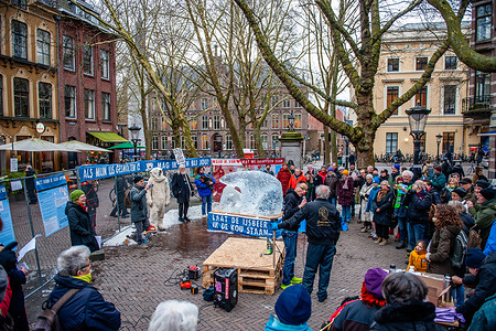 Climate activists are seen surrounding the ice sculpture by Dutch artist, Frank de Conynck. The climate activist organization Extinction Rebellion placed the ice sculpture of a polar bear in the middle of the city melting to symbolize global warming.