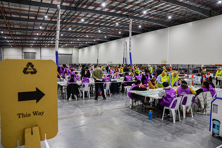 Officials count ballots after voting ended in Australia's general election at a polling station. Vote counting began after polling stations closed at 6:00 PM on 3 May 2025 across all states and territories, including Victoria, in the 2025 Australian federal election. Australian Electoral Commission (AEC) staff are counting the votes. The winning party is announced after the votes are counted.