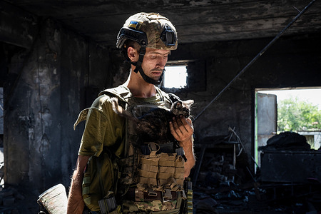 A Ukrainian soldier is seen holding a kitten in a once-Russian-soldiers-base in the newly liberated village of Neskuchne. As the long-awaited Ukrainian counteroffensive started, the Ukrainian armed force is facing strong resistance from the Russian soldiers. Despite they have liberated several villages including Neskuchne, Storozheve, and Blahodatne in the southeast Donetsk region, the counteroffensive remains slow.