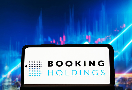 In this photo illustration, the Booking Holdings Inc. logo seen displayed on a smartphone.