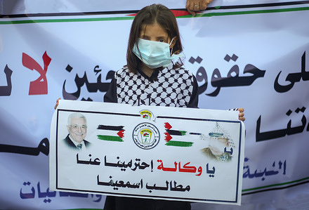 A kid wearing a face mask holds a placard during the demonstration.
Hundreds of Palestinians in the Gaza Strip joined several protests against the reduction of services decided by the United Nations Relief and Works Agency for Palestine Refugees (UNRWA). The Democratic Front for the Liberation of Palestine organized the protests in front of UNRWA's food distribution centers in several refugee camps in the besieged Gaza Strip, home of over 2 million Palestinians.