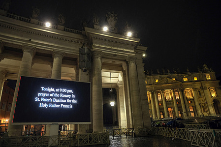 A mega screen at St. Peter's Square shows the start time of the recitation of the Holy Rosary for Pope Francis, hospitalized at the Gemelli Polyclinic for pneumonia, in front of hundreds of faithful.