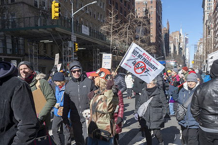 Protesters holding signs march from Union Square to Washington Square Park. A protest against Donald Trump's attempted takeover of the government on Presidents Day during the National Day of Protest.