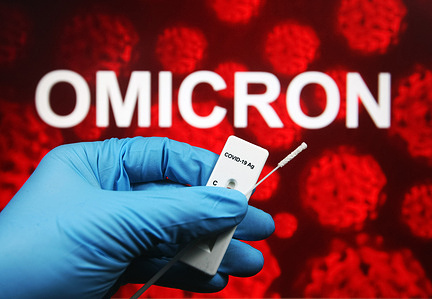 In this photo illustration, a hand holding a COVID-19 antigen express test seen displayed in front of omicron- variant.
A new COVID-19 variant named Deltacron that combine Delta and Omicron variants has been discovered in Cyprus, reportedly by media.