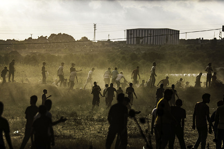Palestinian protesters take part in a demonstration at the border fence with Israel, denouncing the Israeli siege of the Palestinian strip.