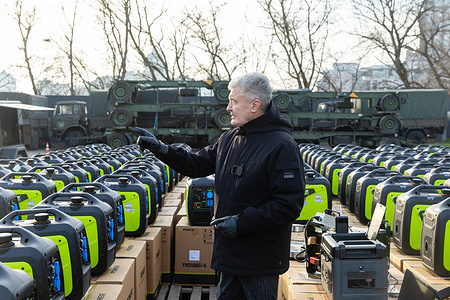 The Fifth President of Ukraine, Petro Poroshenko is seen standing amidst a massive shipment of portable electric generators destined for the Armed Forces of Ukraine, with military logistics equipment visible behind him. Former Ukrainian President Petro Poroshenko delivered 524 generators, including four German units with Deutz engines, to frontline positions of the Ukrainian Armed Forces, meant to power lighting, UAVs, communications, and military gear at over 520 locations. His foundation has now delivered more than 5,000 generators (totaling 30 MW), valued at around 120 million UAH (approximately US $3.2 million). Poroshenko accused authorities of embezzling billions allocated for energy protection, saying the crisis stems from both Russian attacks and corruption.