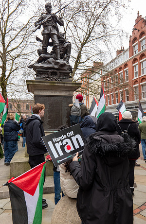 A protester holds a Hands off Iran placard and Palestine flag during the rally. Supporters of Iranian regime, Pro- Palestine and anti war groups held a rally against the Iranian war, Manchester centre saw two Iranian protests. Supporters of Iranian regime change with USA and Israel military action at St Peters square for a rally. Whilst supporters of the existing regime joined antiwar supporters and pro Palestine protesters for a rally at St Anne's square in the centre.