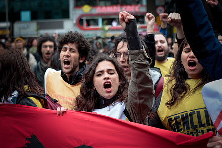 Protesters holding a banner march on Mecidiyekoy Square during the demonstration. Protesters attempted to defy a ban and marched on Taksim Square to celebrate May Day in Istanbul. The demonstration was met with a heavy police presence and restrictions in the area.