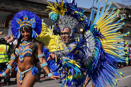 Dressed in vibrant costumes, participants take part in the parade on the second day of the Notting Hill Carnival. The annual event, with roots in Caribbean culture, is the largest street party in Europe.