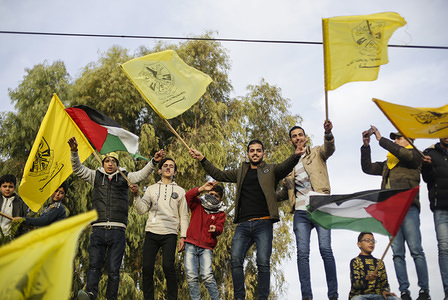 Palestinians waving yellow Fatah flags during a rally marking the 55th anniversary of the Fatah movement founding. Fatah is a secular Palestinian party and former guerrilla movement founded by the late Palestinian leader, Yasser Arafat.
