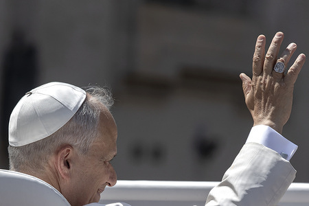 Pope Leo XIV waves as he leaves at the end of his weekly general audience in St. Peter's square at the Vatican.