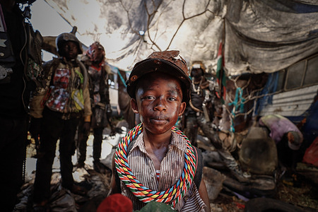 A young boy actor dressed in a post-apocalyptic costume poses for a photo during a film production for a music video. Artists from Kibera dressed up in post-apocalyptic costumes to shoot a music video focusing on finding solutions to the post-consumer textile wastes directed by Stephen Okoth, a local filmmaker from Kibera, Nairobi.