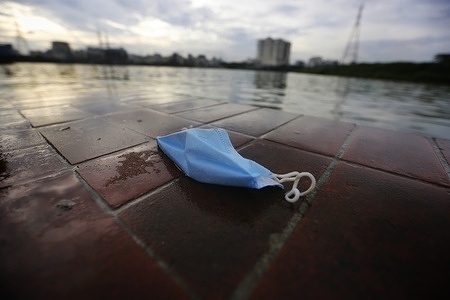 A discarded face mask lies on the ground during the coronavirus pandemic.
Residents of the city are allowed out after the government uplifting lockdown. But discarded face mask, gloves, wipes and bottles of sanitizer are strewn across the parks, sidewalks and roads, as people try to protect themselves and others from infection during the Coronavirus pandemic.