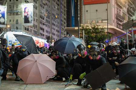 Protesters occupy a road during the demonstration.
Unrest in Hong Kong continues as thousands of protesters took part in a illegal anti government demonstration. Petrol bombs has been thrown by the protesters and the police fired multiple rounds of rubber bullets towards the protesters.
