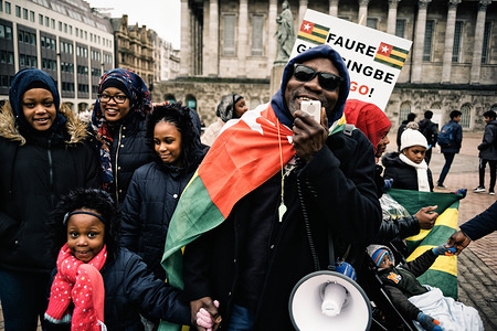 Man uses megaphone to call for action at the 'UK Togolese Diaspora High Council For Democracy and Change' demonstration outside Birmingham Town Hall, protesting the fifty-year rule of the Gnassingbe family. 

Togo, a small nation in West Africa neighbouring Ghana, has seen multiple nationwide protests drawing tens of thousands of people calling for the resignation of President Faure Gnassingbe since 2005. Protesters have demanded electoral reform, asking for the reinstatement of an erstwhile policy of limiting the Presidency to just two terms. In response, security forces have systematically cracked down on these mass demonstrations. Last year, authorities attempted to quell the rising tide of discontent by blocking mobile and Internet communication for temporary periods.