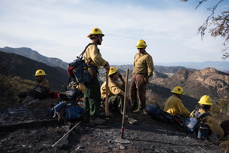 Members of The Scorpions are seen resting after tirelessly clearing breaks in brush, in effort to stop Woolsey fire from spreading. Woolsey Fire has burned 96,949 acres of land and claimed around 435 structures in it's path, leaving three confirmed dead.