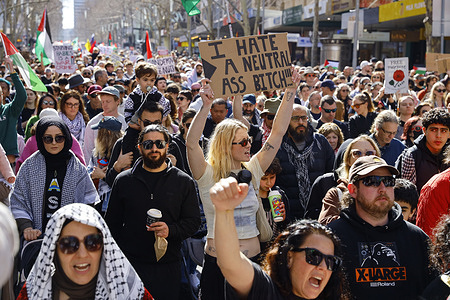 (EDITOR'S NOTE; Image contains profanity)
A protester holds a placard during the rally.  A nationwide rally for Palestine took place across Australia, with marches held in 39 cities and towns, including a large demonstration through Melbourne’s Central Business District (CBD) that drew thousands of protesters. The protests reflect ongoing concerns about Australia’s diplomatic stance toward Israel and Palestine, with many calling for stronger support for Palestinian self-determination and an end to military ties with Israel. The rallies also highlight the Australian government’s balancing act between maintaining relations with Israel and responding to growing public pressure for justice in Palestine.
