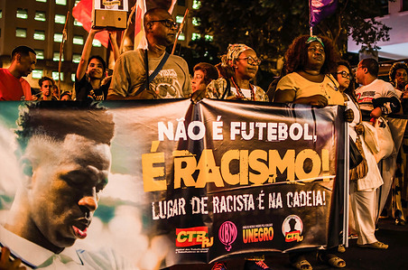 Protesters hold a banner saying "Isn't football, is racism! Place to people racist is in the jail" during the demonstration. Supporters of Real Madrid´s player Vinícius Júnior gathered to show solidarity for the player after suffering racism in Spain against Valencia team on May 21. Vinícius Jr. was a victim of racism and violence when he was called out as ‘mono’ (translation to ‘monkey’) by several football fans while the match happened.