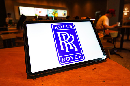 In this photo illustration, a Rolls - Royce logo is displayed on the screen of a tablet.