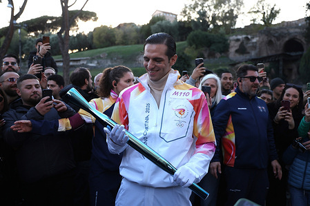 Italian singer Achille Lauro carries the Olympic torch at the Colosseum. Launch of the Olympic Flame’s journey at Stadio dei Marmi marking the official start of the Milano Cortina 2026 Winter Games torch relay.