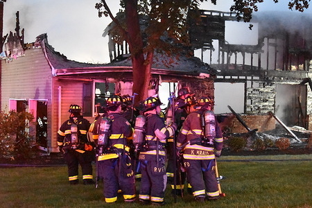 Firefighters on the scene at a burning house on Saturday morning. A second alarm fire destroyed a mansion type house on Maryann Lane in Harrington Park, New Jersey, United States. Multiple fire brigade units arrived at the scene to get the heavy fire under control. The house is uninhabitable and its all damaged due to the fire.