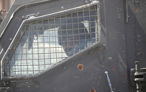 An Israeli soldier seen inside an Israeli army armored vehicle during a raid on neighborhoods in the Askar refugee camp east of Nablus in the West Bank. Israeli soldiers raided neighborhoods and homes in search of weapons and combat equipment belonging to Palestinians wanted by Israeli intelligence.