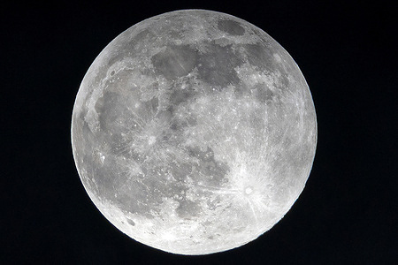 The full Harvest Moon shines brightly in the September night sky over Chiang Mai.
