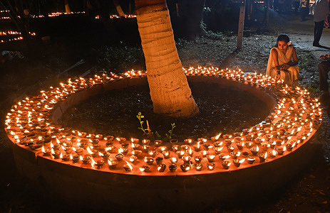 A woman (R) lights an earthen lamp placed around a tree on the occasion of Sharad Purnima (full moon) celebration in Mumbai. Sharad Purnima, also known as the Full Moon Festival, marks the end of the monsoon season. Hindus across South Asia celebrate it in various ways during September and October. Devotees observe fasting and meditate on the full moon night, while Goddess Lakshmi, the deity of wealth, is also worshipped, as it is believed to be her birthday. Praying to her on this day is said to bring good luck and prosperity.