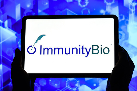 In this photo illustration, the ImmunityBio logo is displayed on the screen of a tablet.