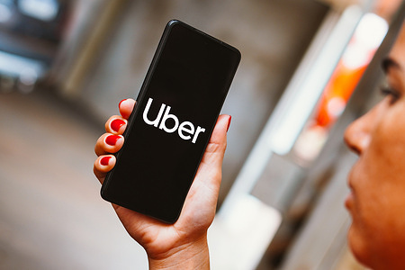 In this photo illustration, the Uber logo is displayed on a smartphone screen.
