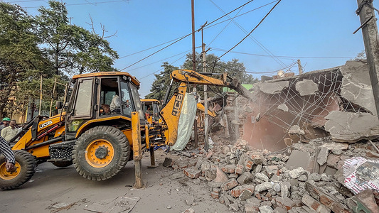 A JCB machine demolishes an illegal makeshift structure during the eviction drive near the Bhuiyadih crematorium in Jamshedpur. Tata Steel UISL and the district administration conduct an eviction drive using JCB machines to demolish long-standing illegal makeshift shops encroaching on the Bhuiyadih crematorium premises in Jamshedpur.