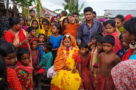 A 14 year old school girl Hafsa sits with friends and neighbors while posing for photos on her wedding day at a village named Joymoni from a coastal area from Mongla in Bagerhat district.
Bangladesh witnessed a 13% increase in child marriages during the Covid-19 pandemic last year as the deadly virus massively affected societies and economies, pushing many into extreme poverty. The gender justice and diversity department of Brac, the world’s largest NGO, found that child marriage increased by 13% when it conducted a survey to access the impact of the Covid-19 pandemic on women and adolescents in 11 districts across the country last year. This is the highest rate of child marriage in Bangladesh in the last 25 years.