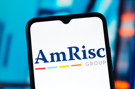 In this photo illustration, the AmRisc logo is seen displayed on a smartphone screen.