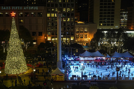 People ski next to a huge Christmas tree at Union Square.