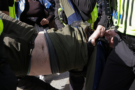 Police officers detain a supporter of Palestine Action for holding a placard during a mass ‘Everyone Day’ protest in Trafalgar Square. The demonstration organised by Defend Our Juries as part of its campaign to end the proscription of the group, opposing what organisers describe as the Home Secretary’s unlawful ban. In March, the Metropolitan Police said officers would resume arresting suspected supporters as a High Court case over the ban continues.