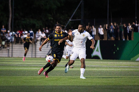 Jesah Ayessa (20) (right) of Paris 13 Atletico and Junior Burban (9) (left) of QRM seen in action during the French Ligue 3 match on matchday 1 between Paris 13 Atletico and Queville-Rouen Metropole at Stade Pele in Paris. Final score : Paris 13 Atletico 1-0 QRM.
