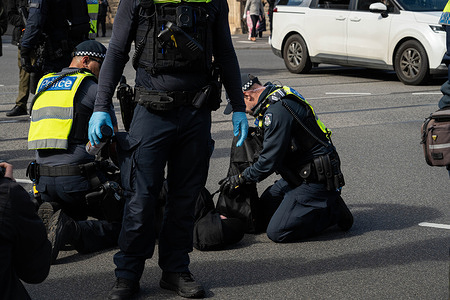 A protester is being arrested during the demonstration. A pro transgender group clashed with police as they attempted to disrupt and counter an anti transgender group. Pepper spray was used, a flare was set alight and 4 arrest were made.