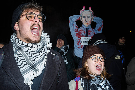 Protesters wearing Keffiyehs chant pro-Palestinian slogans during the demonstration. Pro-Palestine activists gathered at the Polish President's Chancellery to protest the government's decision to extend immunity to Benjamin Netanyahu from an International Criminal Court arrest warrant during his potential visit for the 80th anniversary of Auschwitz's liberation. Protesters marched to the Prime Minister's office, demanding the withdrawal of any immunity offer for the Israeli leader.