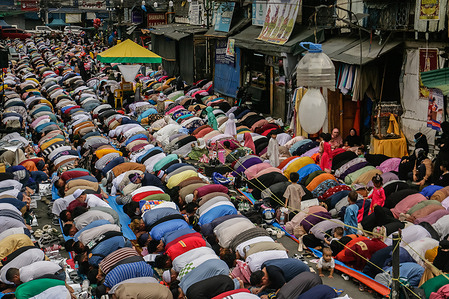 Filipino Muslims pray in the street, outside of the Golden Mosque in Quiapo, Manila during the observance of Eid al-Fitr. Eid al-Fitr is one of the sacred religious holiday observed by Muslims worldwide. It is the end of Ramadan, the Islamic holy month of fasting. In Islamic culture, fasting during Ramadan is a way to purify oneself and draw closer to God.