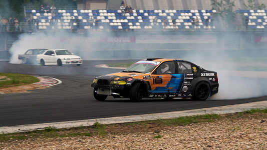A black BMW cornering during the event.
Festival Drift Expo Track Mode runs on May 29-30 at ADM Raceway with the exhibition of projects modified for drifting such as; ‘Drift Taxi’ - an opportunity to ride as a passenger with a professional driver in a specially prepared sports car on the race track, ‘Drift Trike Area’ - a platform where you can try driving a real drift trike and ‘RC Drift’ - drift on radio controlled cars.