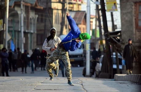 A Kashmiri protester throw stones at Indian government forces during an anti India protest in Srinagar. Authorities imposed movement restrictions today in parts of Srinagar in response to a call for a protest march by the Kashmir's Joint Resistance Leadership (JRL) against the civilian killings in Kashmir and Indian rule of the region.