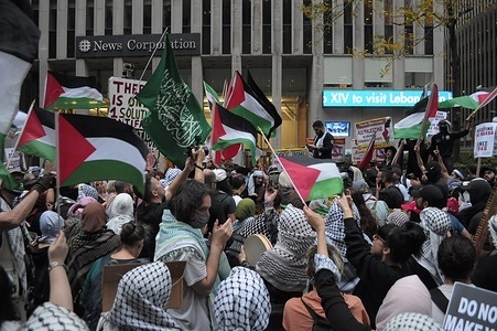 Pro-Palestine demonstrators wave Palestinian flags at a rally outside of the News Corp. Building, home of Fox News studios. Pro-Palestine demonstrators rallied in Manhattan, New York City on the two-year anniversary of the Israel-Hamas War. Demonstrators condemned the Prime Minister of Israel, Benjamin Netanyahu, and the Israel Defense Forces for their ongoing military operations in Gaza.