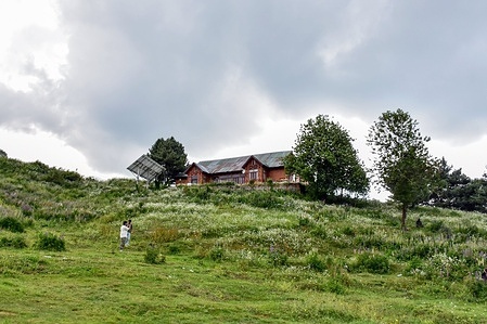 Visitors walk through the meadow during a cloudy weather at the Gulmarg hill station, about 55kms from Srinagar, the summer capital of Jammu and Kashmir.