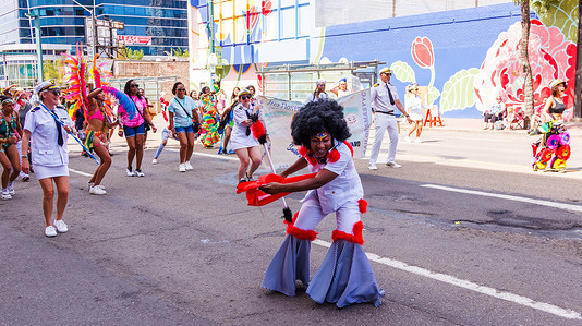 Members of the Inaugural Tribute to Sailor Mas Band are having some fun for the crowds in the Cariwest Parade on day 2 of Cariwest Festival in Edmonton. On August 9, 2025, Day 2 of the Cariwest festival was highlighted by the Annual Cariwest Parade, which brought Mas Bands from across the Caribbean to downtown Edmonton. From noon to 2:30 p.m., the parade filled the streets with vibrant costumes, music, and dancing, beginning at 108 Street and 99 Avenue and ending at Sir Winston Churchill Square.