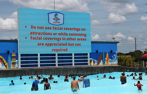 An advisory about face coverings is displayed at the wave pool at Island H2O Live! water park as the attraction becomes the only major water park in the Orlando area to reopen for Memorial Day weekend after closing for the coronavirus pandemic. 
The park will limit capacity and encourage social distancing and the wearing of face coverings when not on an attraction or swimming.