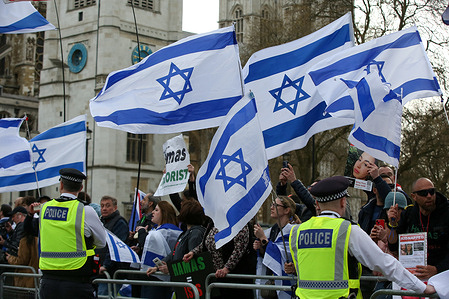 Counter-protesters wave Israeli flags during the Al Quds Day protest organised by Justice For Palestine Committee. The annual event takes place in support for Palestine and oppose the Israeli occupation of Palestinian territories.