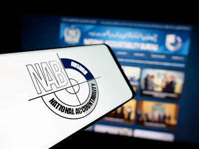In this photo illustration, a smartphone with the logo of Pakistan National Accountability Bureau (NAB) is seen on screen in front of website.