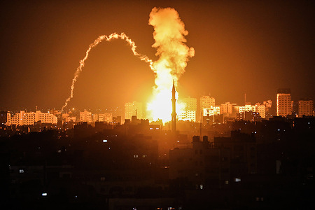 Smoke rises above the buildings in the Palestinian enclave in Gaza City. The Israeli military traded fire with Gaza militants on May 2, 2023, in a flare-up of violence following the death of Khader Adnan. Adnan is a leader in the Islamic Jihad militant group, imprisoned under Israeli custody since Feb 5. After his arrest, he went on a hunger strike as a protest against the Israeli unlawful detention of Palestinians, and on his 87th day of the hunger strike, he died in Israeli prison. Palestinian government accused the Israeli government that they are responsible for Adnan's death for not approving his release and attending to his medical needs.